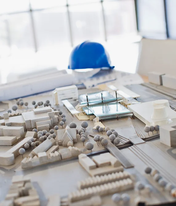 An architectural model with a hard hat