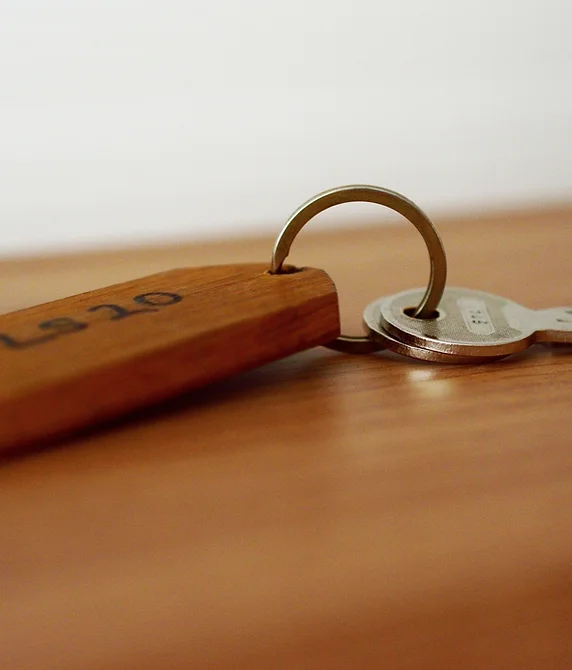 A house key on a wooden keyring